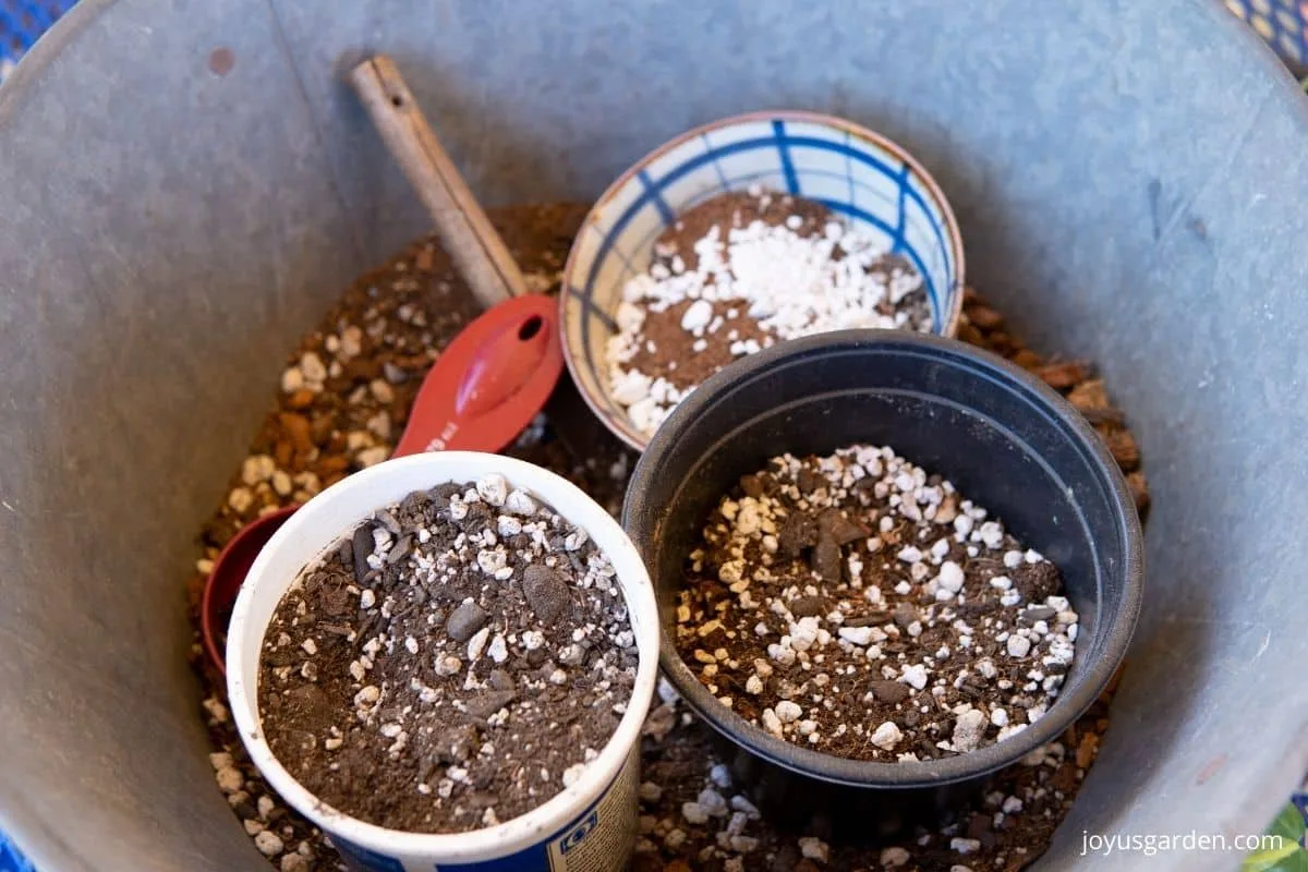 looking down on a tin bin with plant potting materials