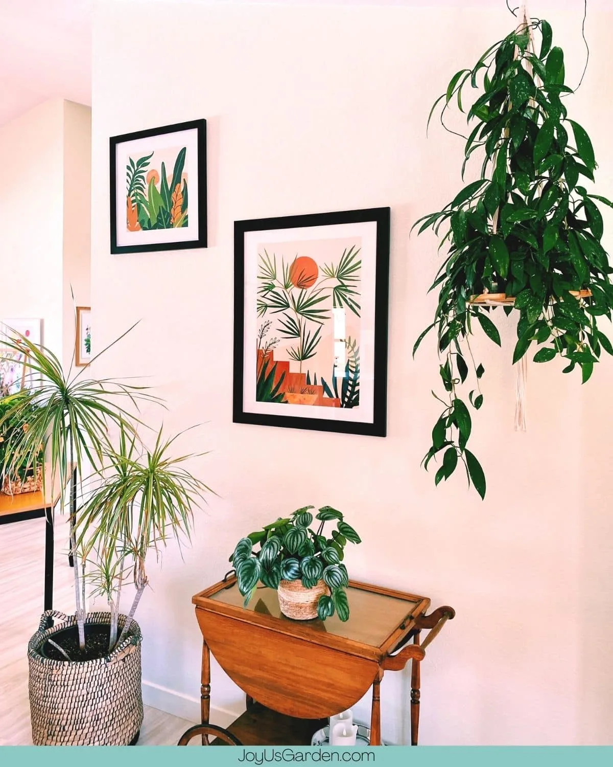 Tropical plant wall art displayed with houseplants in a dining room.