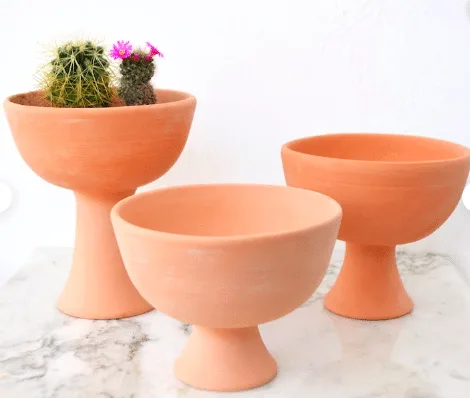 Three terra-cotta pots and bowls shape with stand from Etsy.