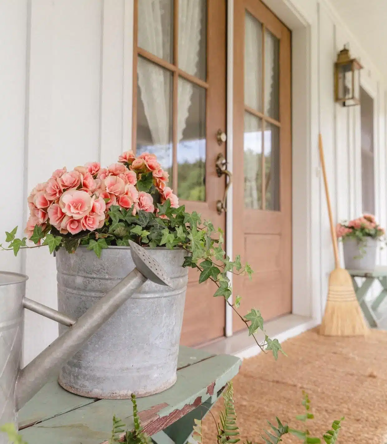 pink faux flowers in a metal bucket