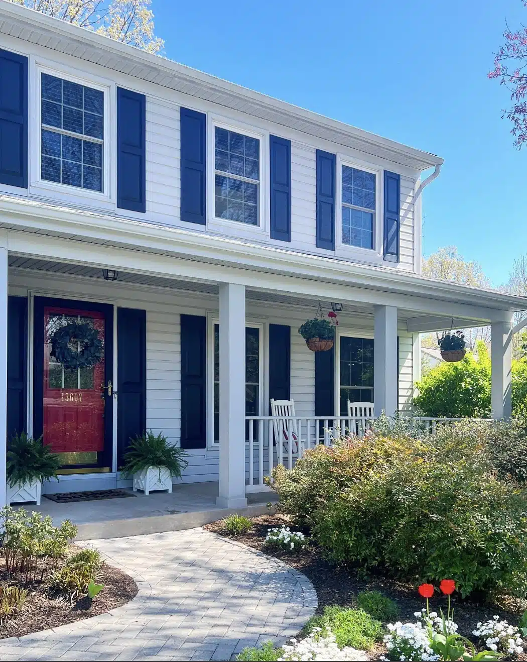 hanging flower planters on a colonial home