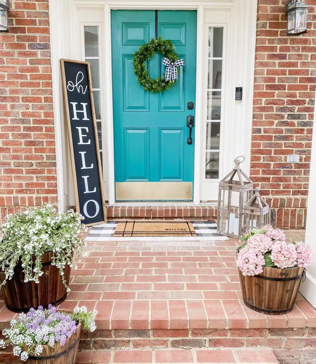 pink and purple flowers in Wood Barrels on a front porch